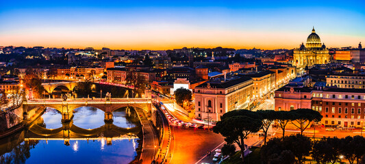 Night view of St. Peter's Basilica and the Tiber river in Vatican City, Rome, Italy
