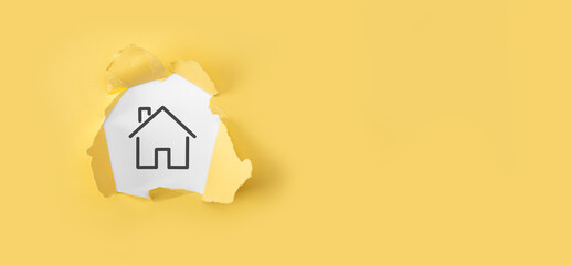 Real estate concept, businessman holding a house icon.House on Hand. Torn yellow paper with house...