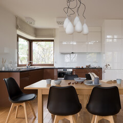 Wooden dining table in spacious kitchen