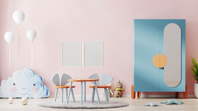 Blank poster frames mock up in beautiful children room interior with pink wall, colorful furniture and soft toys, kids playroom interior background, nursery, 3d rendering