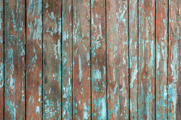 Green old cracked paint on a wooden surface. Background from wooden boards with peeling paint top...