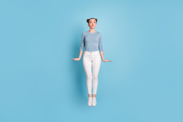 Full size photo of cute charming woman send air kiss jump up isolated on pastel blue color background