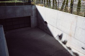 A modern concrete entrance to the underground garage made of prefabricated elements in a new housing estate.