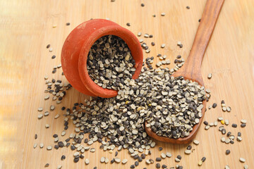 Split Black Lentil Also Know as Black Gram, Black Urad Dal, Vigna Mungo, Urad Bean on wooden background.