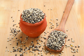 Split Black Lentil Also Know as Black Gram, Black Urad Dal, Vigna Mungo, Urad Bean on wooden background.