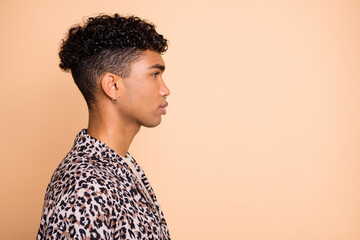 Profile portrait of brunet optimistic guy look empty space wear modern shirt isolated on beige color background © deagreez