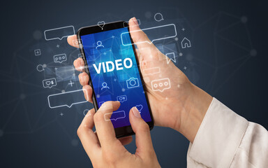Hand using smartphone with social media concept