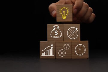 Concept of business strategy and action plan. Wood cube block stacking with icon