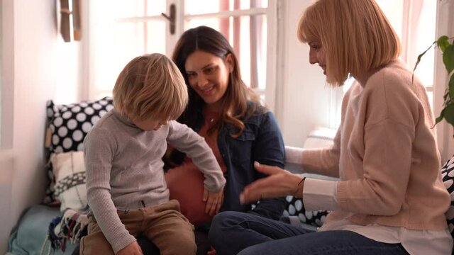 Happy gay couple playing with her son together