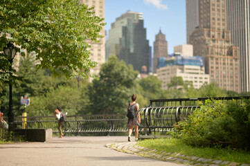 people strolling in summer city park