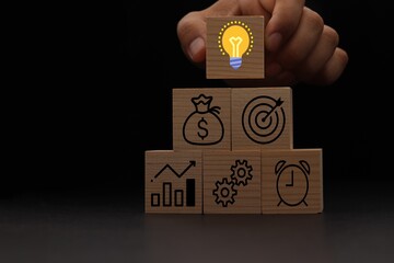 Concept of business strategy and action plan. Wood cube block stacking with icon