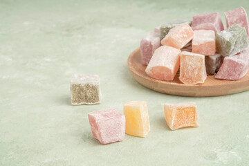 colorful Turkish delights on the plate on green