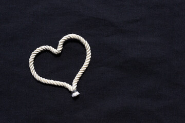 A heart shaped knot made of white rope. Love concept.