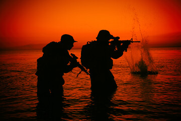 Army soldiers team, special operation forces infantrymen landing on seacoast, aiming and shooting...