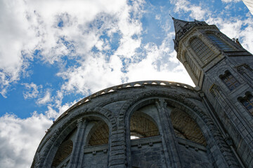 View of the Basilica of Lourdes in low angle and against the light, a feeling of grandeur in this important place of pilgrimage of the Catholic Church