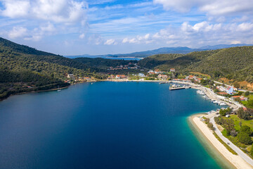 Fototapeta na wymiar Panoramic top view on Mediterranean sea blue water with white sandy beach road along green hills coastline, yachts and boats pier, tourist hotels, summer vacation villas
