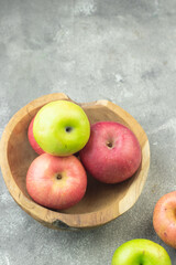 Buah Apel or apples fruits on grey grainy wooden background. Copy space for text and template. 