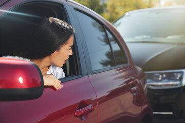 Young woman getting in car accident outdoors