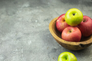 Buah Apel or apples fruits on grey grainy wooden background. Copy space for text and template. 