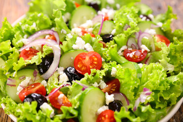 vegetable salad with lettuce, tomato, cucumber and cheese