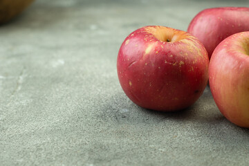 Buah Apel or apples fruits on grey grainy wooden background. Copy space for text and template. 