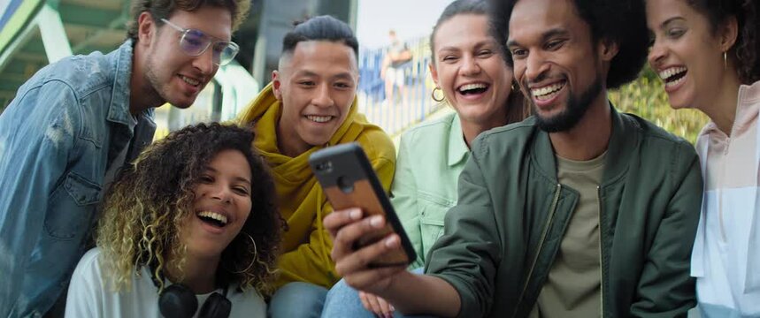 Video of happy group of young friends using mobile phone. Shot with RED helium camera in 8K. 