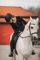 Obraz premium Young caucasian woman riding a horse in a horse centre
