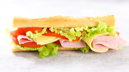 sandwich- baguette with ham, cheese, lettuce and tomato