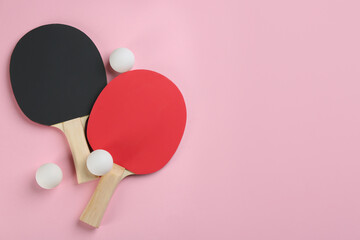Ping pong rackets and balls on pink background, flat lay. Space for text