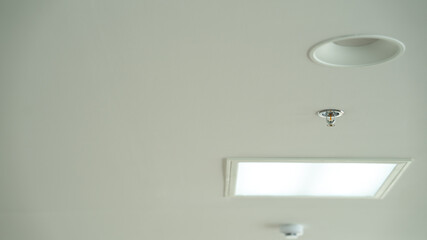 Smoke detector and pendent fire sprinkler on a ceiling,fire emergency  Fire Sprinkler and Smoke, Detector installed in the building.