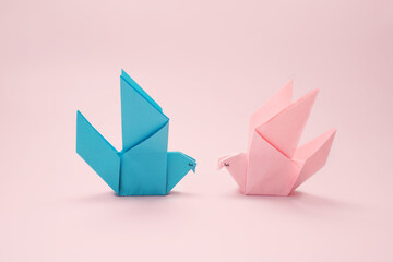 Origami birds blue and pink symbolizing love and romance