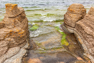 Sea stack by the sea with rolling waves
