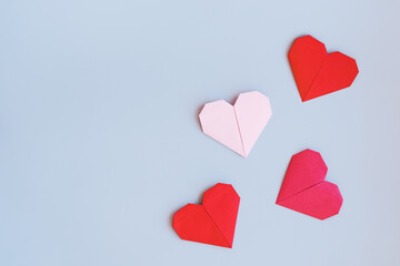 Romantic background with hearts made on the principle of origami paper, space for text, top view