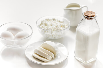 monochrome concept with dairy products on white table