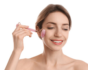 Young woman using natural rose quartz face roller on white background