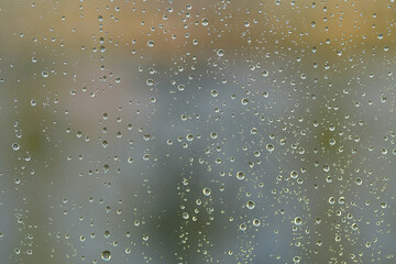 Cold drops of autumn rain on the window pane
