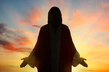 Silhouette of Jesus Christ outdoors at sunset