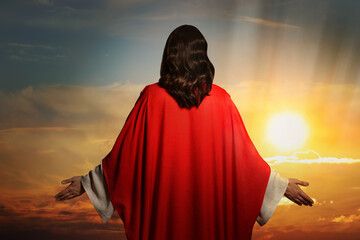 Jesus Christ outdoors at sunset, back view