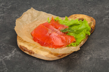 Sliced salmon fillet served rosemary
