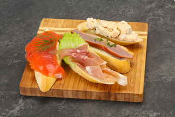 Tapas - bruschetta with prosciutto, salmon, duck and gorgonzola