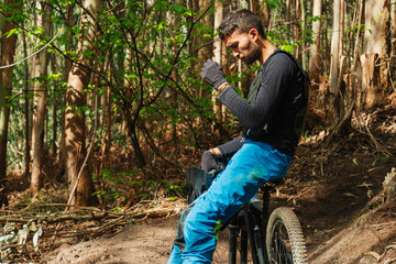 Fototapeta na wymiar Biker taking a breathe the path with his mountain bike