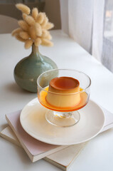 Dessert caramel pudding on a white table.