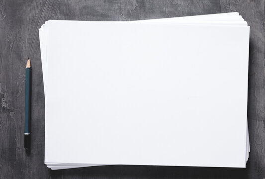 Stack Of Paper Sheet And Pencil With Empty Pages On Abstract Table Background