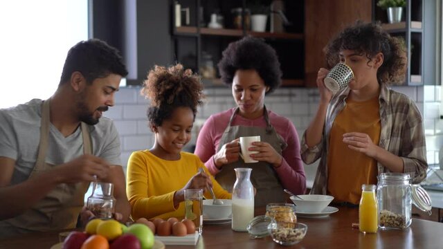 Happy family having breakfast at home