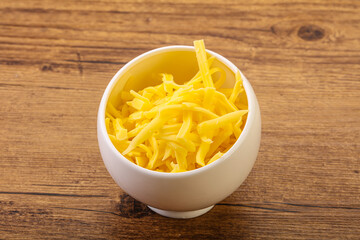 Shredded yellow cheese in the bowl
