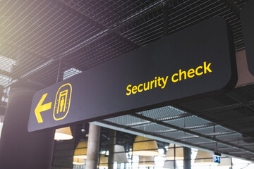 Airport informaction signs. Arrow on information screen leading to security check