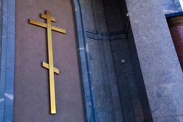 Cross on the wall of the temple, golden cross, orthodox cross