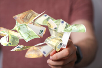 euro bills flying around  in hand
