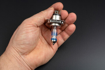 blue car lamp in a man's hand close-up