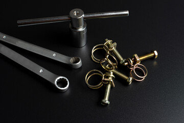 metal wire clamps and tools on black background